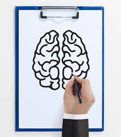 businessman drawing a human brain on a a notepad