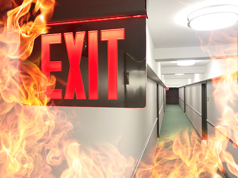 Emergency exit sign during fire with flames