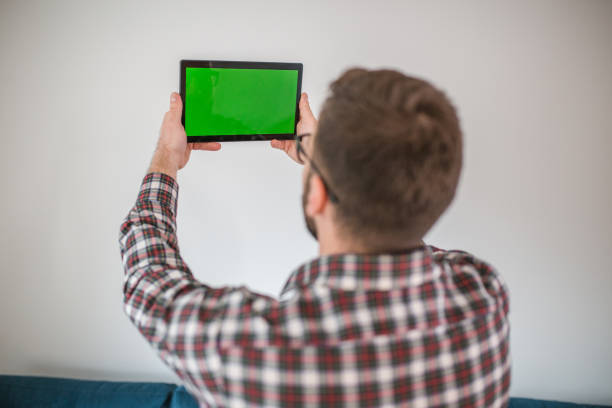 istock Rear view of a man rejoicing while winning online gambling 1472439119