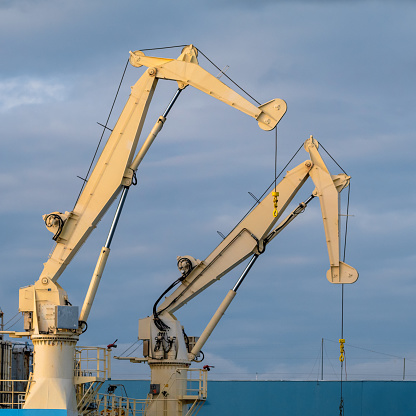 Two large cranes on an industrial ship docked in Victoria, British Columbia.