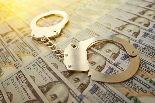 Banknotes dollars money and handcuffs. corruption or fraud. money laundering concept