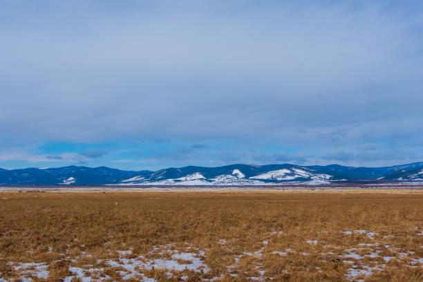 istock Spring valley view and mountains on horizon under Blue Sky and white fluffy clouds 1472444356