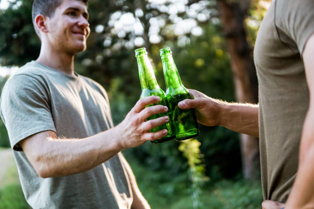 istock Two men clinking beer in nature, cheers, having a celebrating toast 1472445421