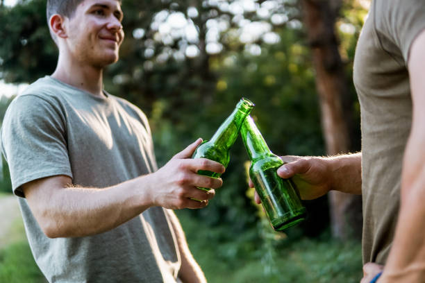 istock Two men clinking beer in nature, cheers, having a celebrating toast 1472445422