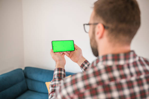 istock Unrecognizable man gambling at home using a mobile phone 1472446188