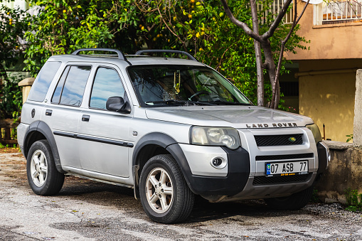 Side, Turkey -January 29, 2023:   gray  Land Rover Freelander  parked in the old tourist city, front view