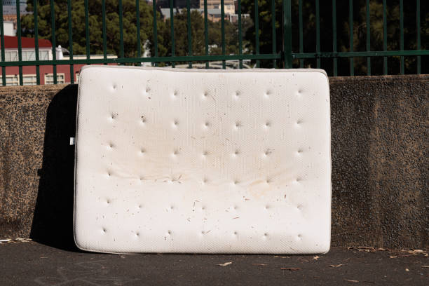 istock Discarded old mattress on the side of a road 1472447334