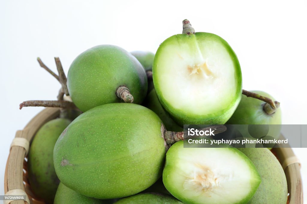 hog plums or Spondias mombin, Fresh ambarella, mombin hog plum fruit on bamboo colander on a white background. Antioxidant Stock Photo