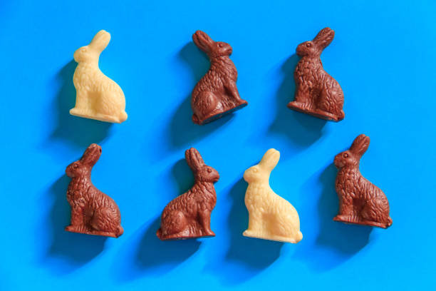 istock Easter chocolate bunnies on blue background. Top view 1472451368