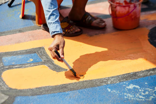 istock Person painting on the playground surface 1472452256