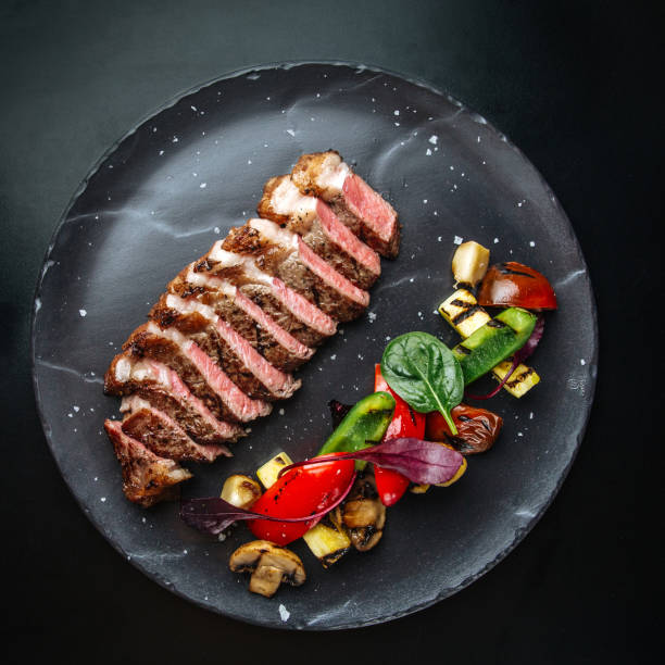 istock Sliced roast beef with herbs and vegetables 1472455123