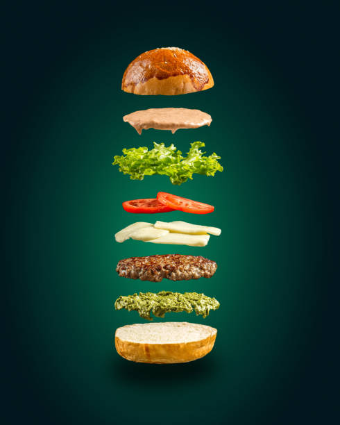 istock Floating burger ingredients on the green background 1472455328