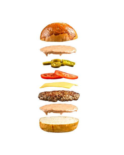 istock Isolated floating burger ingredients on the white 1472455340