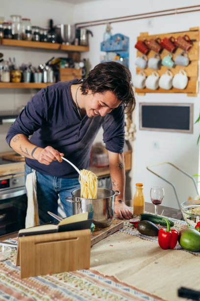 man prepares food ih home kitchen