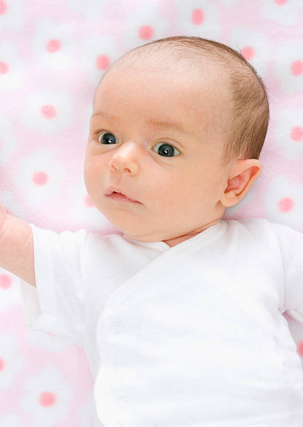 Baby on pink blanket stock photo