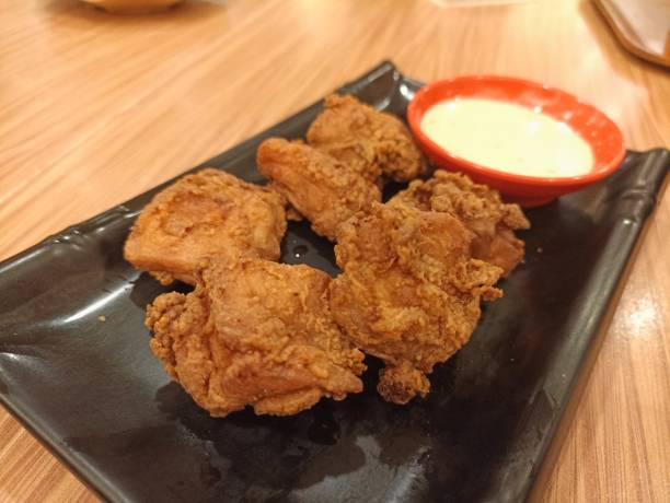 istock chicken karaage or fried chicken on a black plate with sauce 1472459472