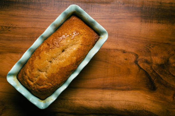 istock Pound cake in blue mold on wooden table. 1472460793