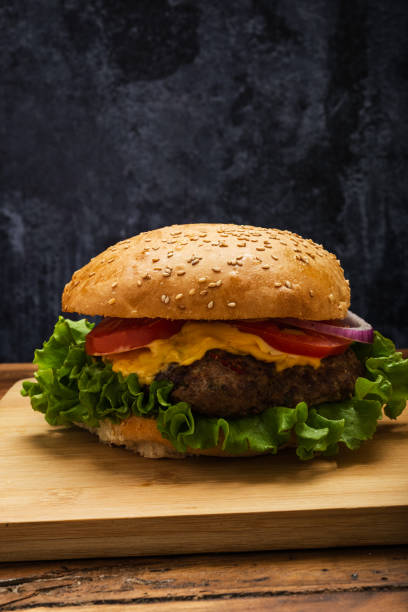 istock Homemade hamburger on a wooden table. 1472460983