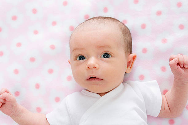 Baby on polka dot blanket stock photo