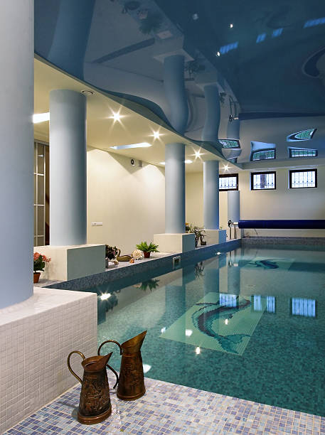Indoor swimming pool and spa with reflective ceiling stock photo