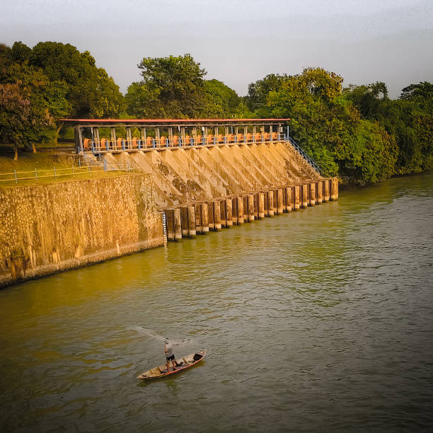 Traditional fisherman catching fish near water dam