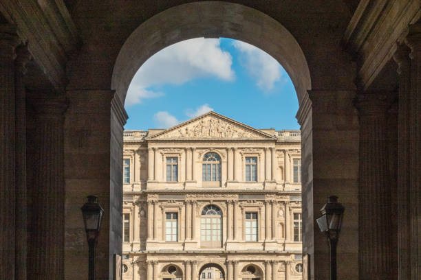 A small part of the Louvre (Paris, France), seen through one of its many gates A small part of the Louvre (Paris, France), seen through one of its many gates musee du louvre stock pictures, royalty-free photos & images