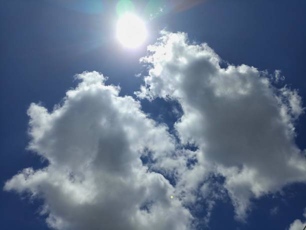 istock sunny day with white clouds and blue sky 1472465602