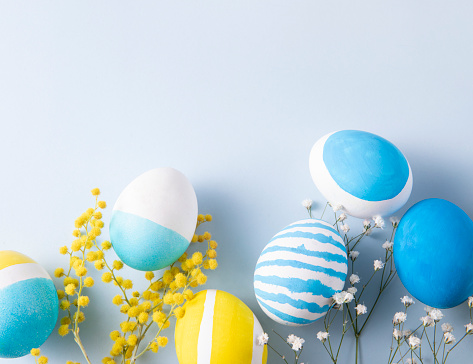 Colorful dyed easter eggs on blue background