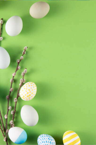 istock Flowers and Coloured Easter Eggs on Light Green Background 1472466059