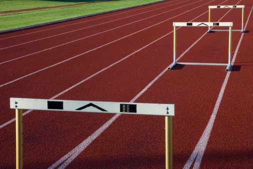 red running tracks with three hurdles set up for training