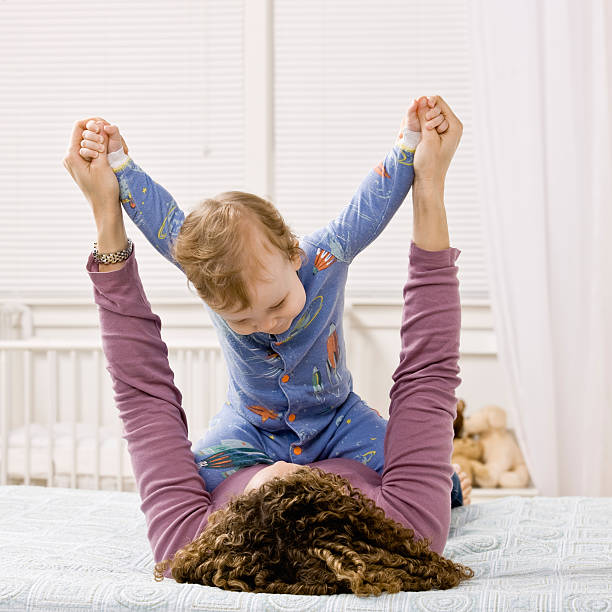istock Mother playing with son on bed 147246684