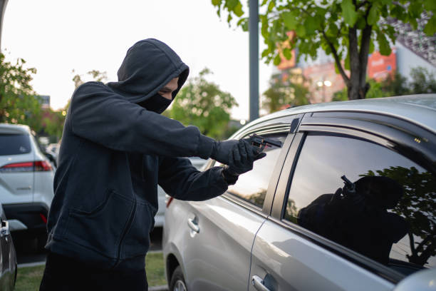 istock Terrorist or car thief pointing gun at driver 1472467298