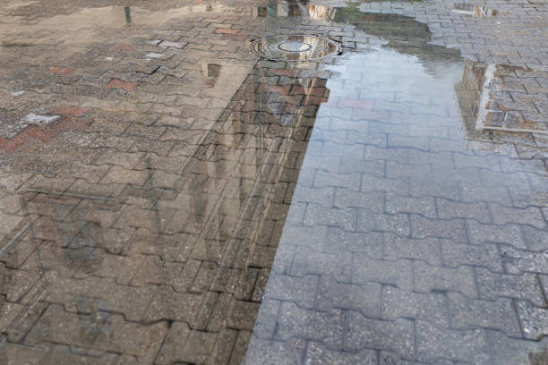istock Reflection in puddles after rain. Rainy weather 1472468242
