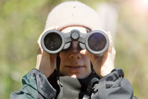 istock Outdoor woman, nature explorer with binoculars 1472469731