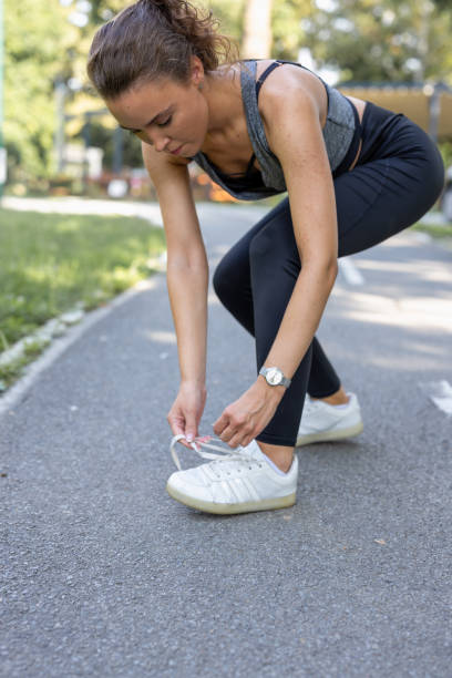 istock A young woman tying her laces in the running session 1472472632
