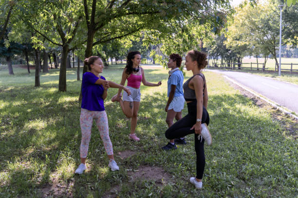 istock Female athletes stretching in the nature 1472472736