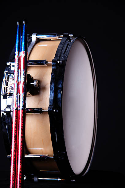 istock Maple Wood Snare Drum and Sticks Isolated On Black 147247286
