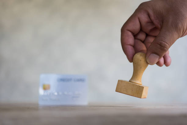 istock Hand use rubber stamp and with blur background white credit card. 1472472897