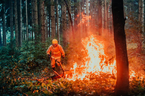 istock firefighter hero in action danger jumping over fire flame to rescue and save 1472474265