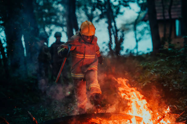 istock firefighter hero in action danger jumping over fire flame to rescue and save 1472474369