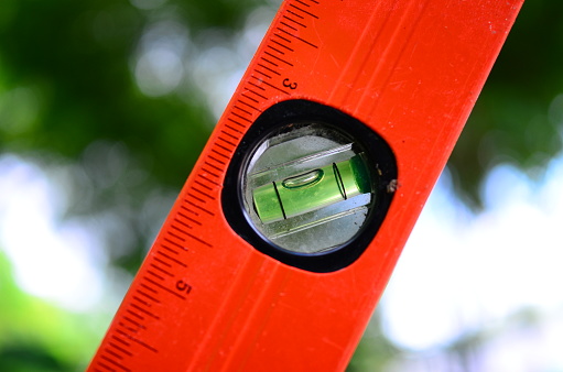 Close-up of a yellow tape measure. Shallow depth of field, space for copy.