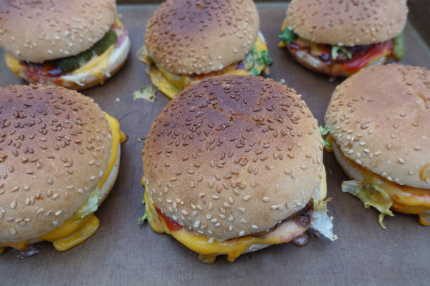 istock Homemade cheeseburger on a baking sheet after baking 1472475738