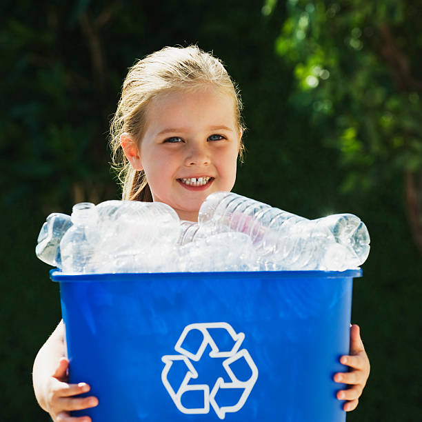 istock Little Girl Holding Recycling Bin 147247671