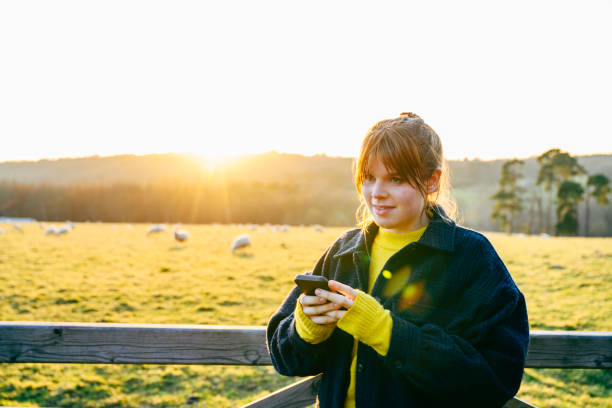 istock Young rural resident text messaging at day's end 1472476751
