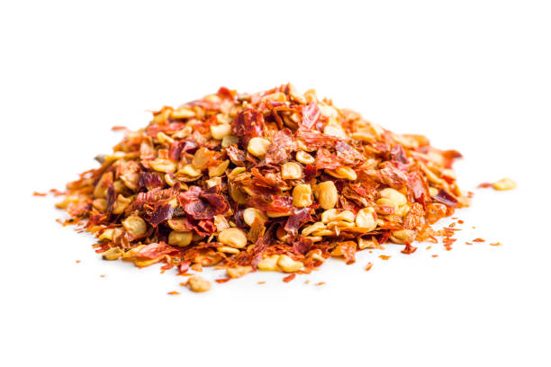 istock Dry chili pepper flakes. Crushed red peppers isolated on white background. 1472477093