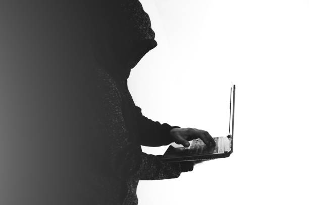istock Man in hoodie is hacking personal data. Information security. Protection of information concept. Bad password. 1472477809