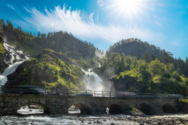 latefossen is one of the most visited waterfalls in norway and is located near skare and odda in the region hordaland, norway. consists of two separate streams flowing down from the lake lotevatnet. - bridge norway odda falling imagens e fotografias de stock