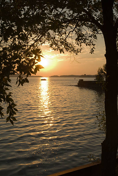 bateau sur le lac portage au coucher du soleil - portage lake photos et images de collection