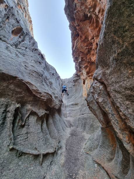 istock A hiker climbing up a narrow gully 1472481328