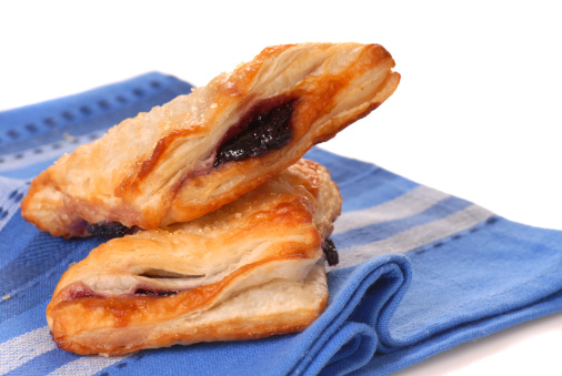 Freshly baked blueberry turnovers resting on a napkin